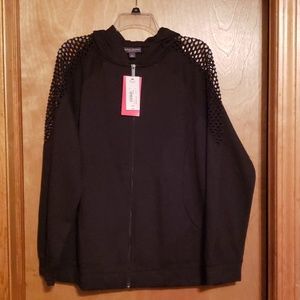 Black zip up hoodie with shoulder cutout detail.